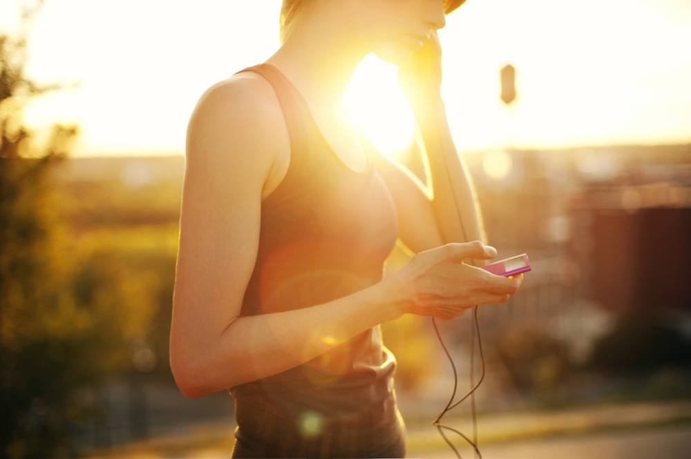 Woman Listening To Music At Sunset